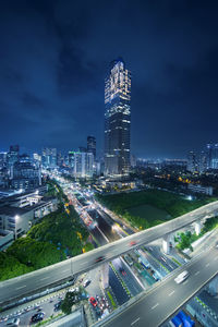 High angle view of illuminated buildings against sky at night