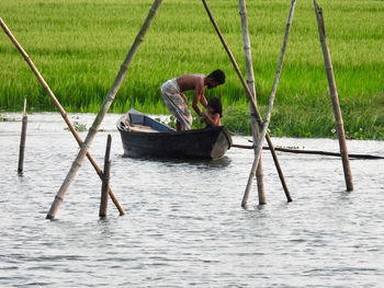 Fisherman with his daughter on boat 