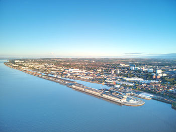 High angle view of city against blue sky