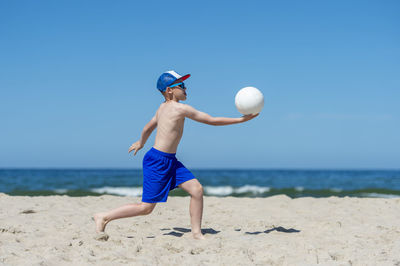 Man playing with ball on beach