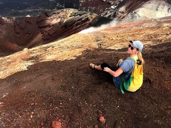 Woman sitting on rock