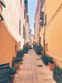 Alley amidst buildings against sky