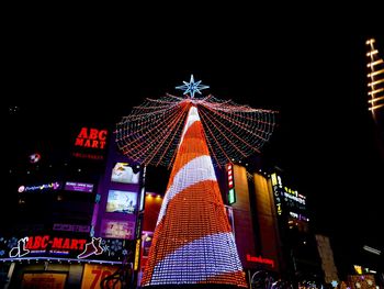 Low angle view of illuminated ferris wheel at night