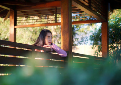 Portrait of woman sitting on bench