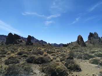 Scenic view of rocky mountains against blue sky