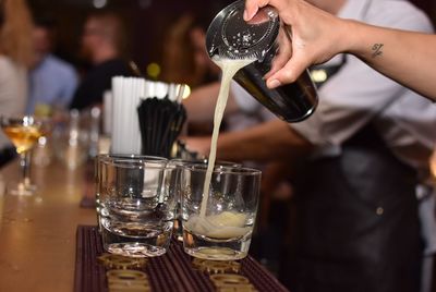 Close-up of man pouring wine in glass