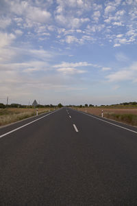 Road between wheat fields before harvest, colors of nature