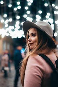 Portrait of smiling young woman wearing hat