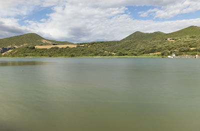 Scenic view of lake and mountains against sky