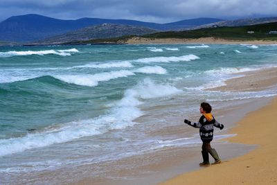 Rear view of boy on beach