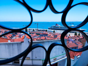 Buildings and sea seen through window