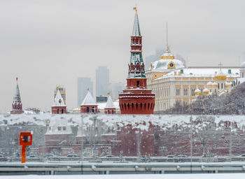 Communications tower in city during winter