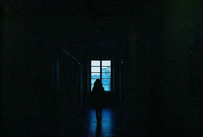 Man and woman in window against sky