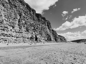 Rock formations on land against sky