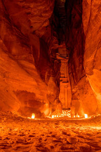 The siq canyon illuminated by candles at night. petra, jordan