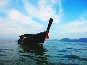 Ship moored in sea against sky