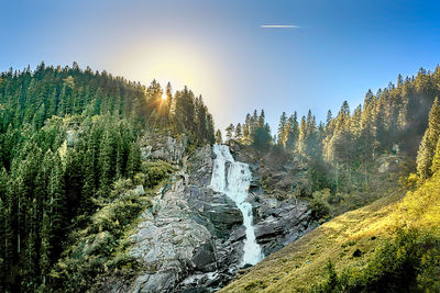 Scenic view of waterfall against sky