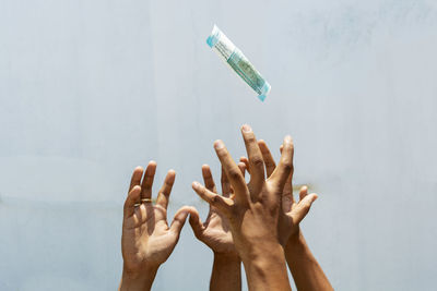 Low angle view of people hands in water