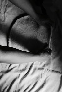 Midsection of person relaxing on bed