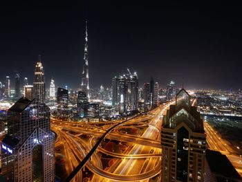 High angle view of illuminated city buildings at night