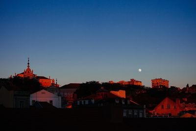 Buildings in city against blue sky
