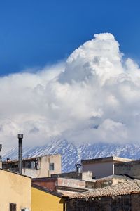 View of cityscape against blue sky