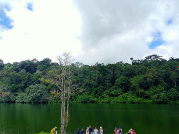 Scenic view of lake by trees against sky