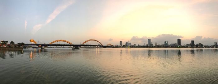 Panoramic view of bridge over river against sky during sunset
