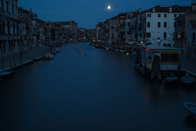 Canal passing through city at night