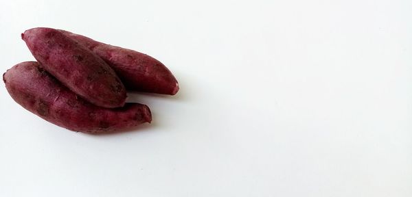High angle view of red chili over white background