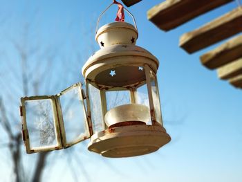 Low angle view of bell hanging against sky