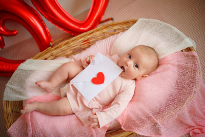 Valentine's day, little girl with valentine envelope