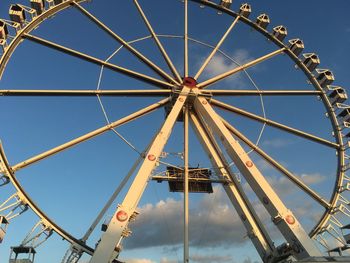 Low angle view of ferris wheel against blue sky