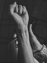 Low section of woman holding hands