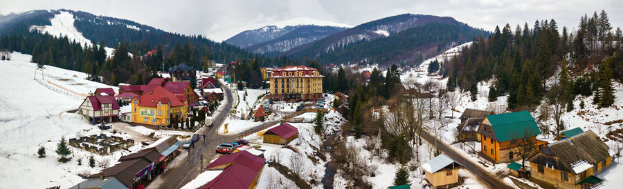 High angle view of trees and houses against sky during winter