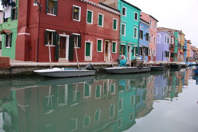 Reflection of man on boat in water