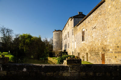 Low angle view of old building against clear sky