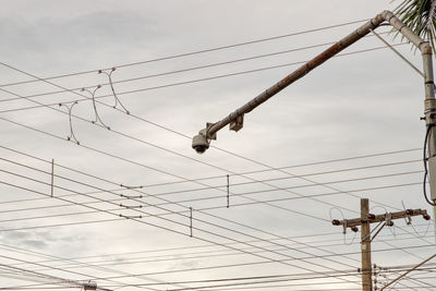 Low angle view of electricity pylon against sky