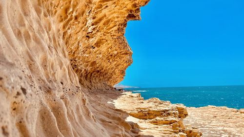 Scenic view of sea against clear blue sky