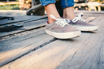 Low section of woman standing on deck