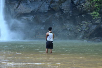 Full length of man standing on rock