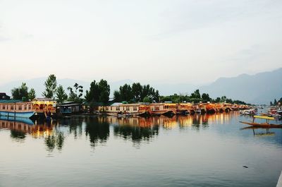 Boats on calm lake with mountains in background