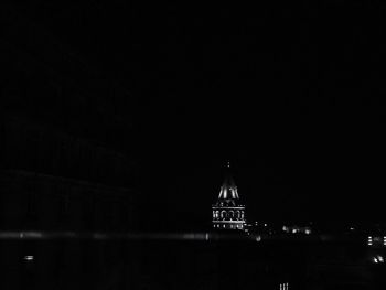 Illuminated building against sky at night