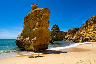 Golden sandstone cliffs overlooking the praia da marinha, algarve, portugal