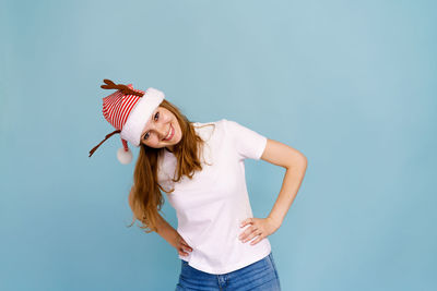 Portrait of an excited smiling caucasian girl dressed as christmas deer