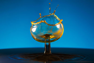 Close-up of drop against blue background