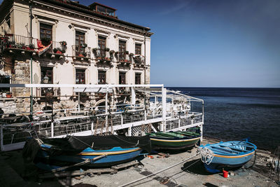 Boats moored at harbor