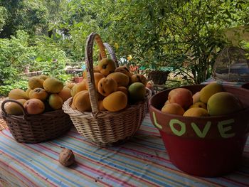 Mangoes in wicker basket on table