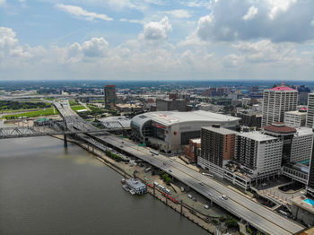 High angle view of river amidst buildings in city against sky