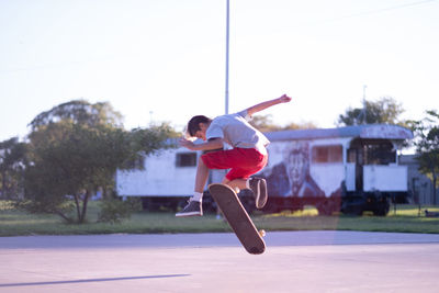 Portrait of teen skateboarder doing a trick